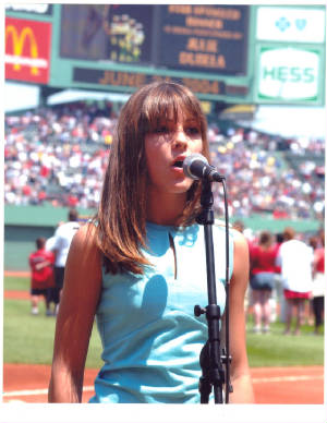 Photo of Julie Dubela singing the National Anthem at Fenway Park