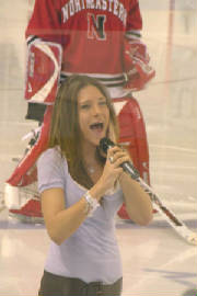 Photo of Julie Dubela singing the National Anthem at UNH hockey game
