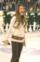 Photo of Julie Dubela singing the National Anthem at UNH hockey game