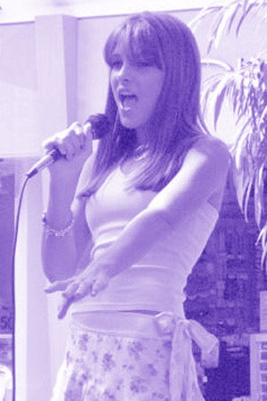 Photo of Julie Dubela singing at the MDA Talent Showcase