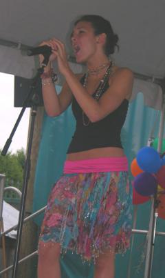 Photo of Julie Dubela singing at concert at Six Flags